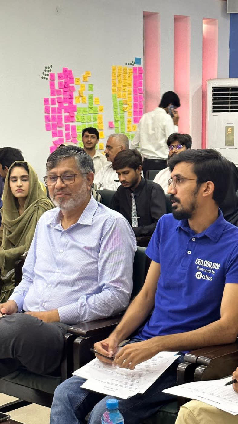 Umair Majeed with a score sheet as a judge at the Regional Plan9 Launchpad final round, Multan, July 2023